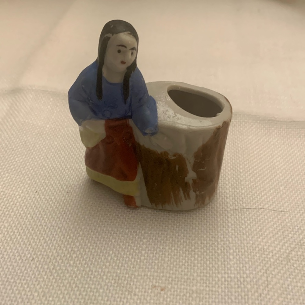 Vintage Native American Indian girl toothpick holder next to a tree stump